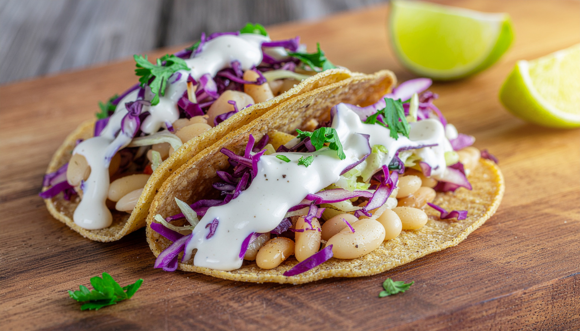 Crispy White Bean Smash Tacos - Golden crispy tortillas filled with smashed beans and cabbage